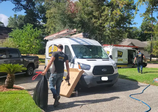 Ranger team unloading equipment from their branded van at a job site